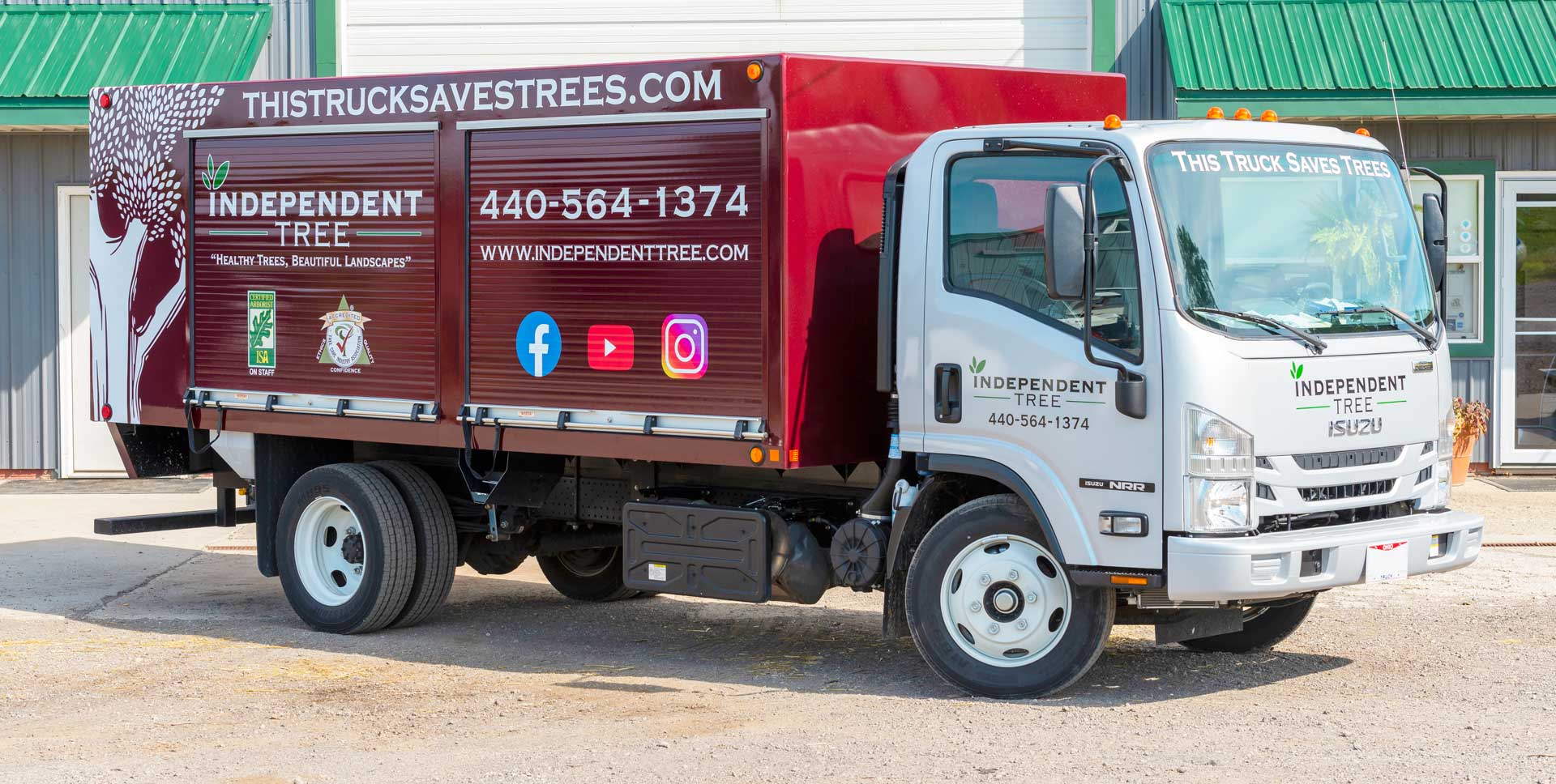 red truck with "this truck saves trees" and Independent Tree logo