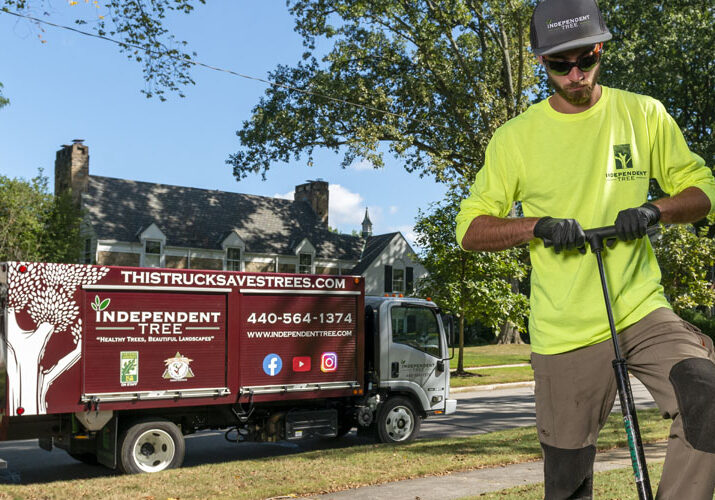 An Independent Tree employee uses PHC truck injections to protect a home from pests and diseases